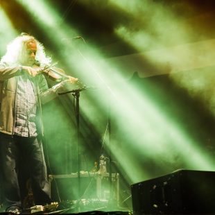 Tim Carbone of Railroad Earth saws away on Saturday night at the fest.