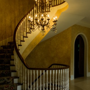 As you enter the home, a grand staircase and complementary chandelier.