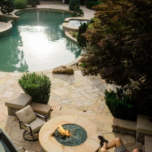 The backyard's fire pit, hot tub, and guitar-shaped swimming pool.