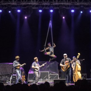 An aerialist of the Torch Sisters is a mesmerizing backdrop to Pert Near Sandstone.