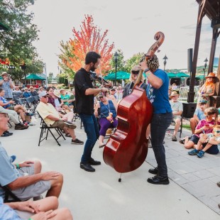 Jake Blount and band step off the stage to perform among the crowd when technical difficulties interrupted the beginning of their set. Photo by Cora Wagoner