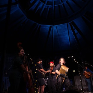Della Mae's rousing late night set on the Foggy Mountain stage, complete with an appearance by BGS managing editor Justin Hiltner on banjo. Photo by Eli Johnson