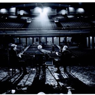 A behind-the-scenes shot of Ricky Skaggs, Doc Watson, and Earl Scruggs preparing for 'The Three Pickers.'