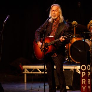 Jim Lauderdale, who also led a Tai Chi session during the conference, performs at the opening night concert.
