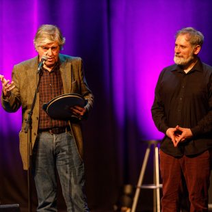 Flanked by Brendan McCreanor (right), Paddy Glackin accepts the Anam Awards on behalf of his friend, Paddy Keenan of the Bothy Band.
