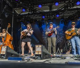 Della Mae (Vickie Vaughn, bass; Celia Woodsmith, guitar; Kimber Ludiker, fiddle; Avril Smith, guitar). Earl Scruggs Music Festival 2026. Photo Credit: Bain Stewart